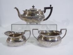 A late Victorian, three piece, silver tea service with gadrooned decoration,