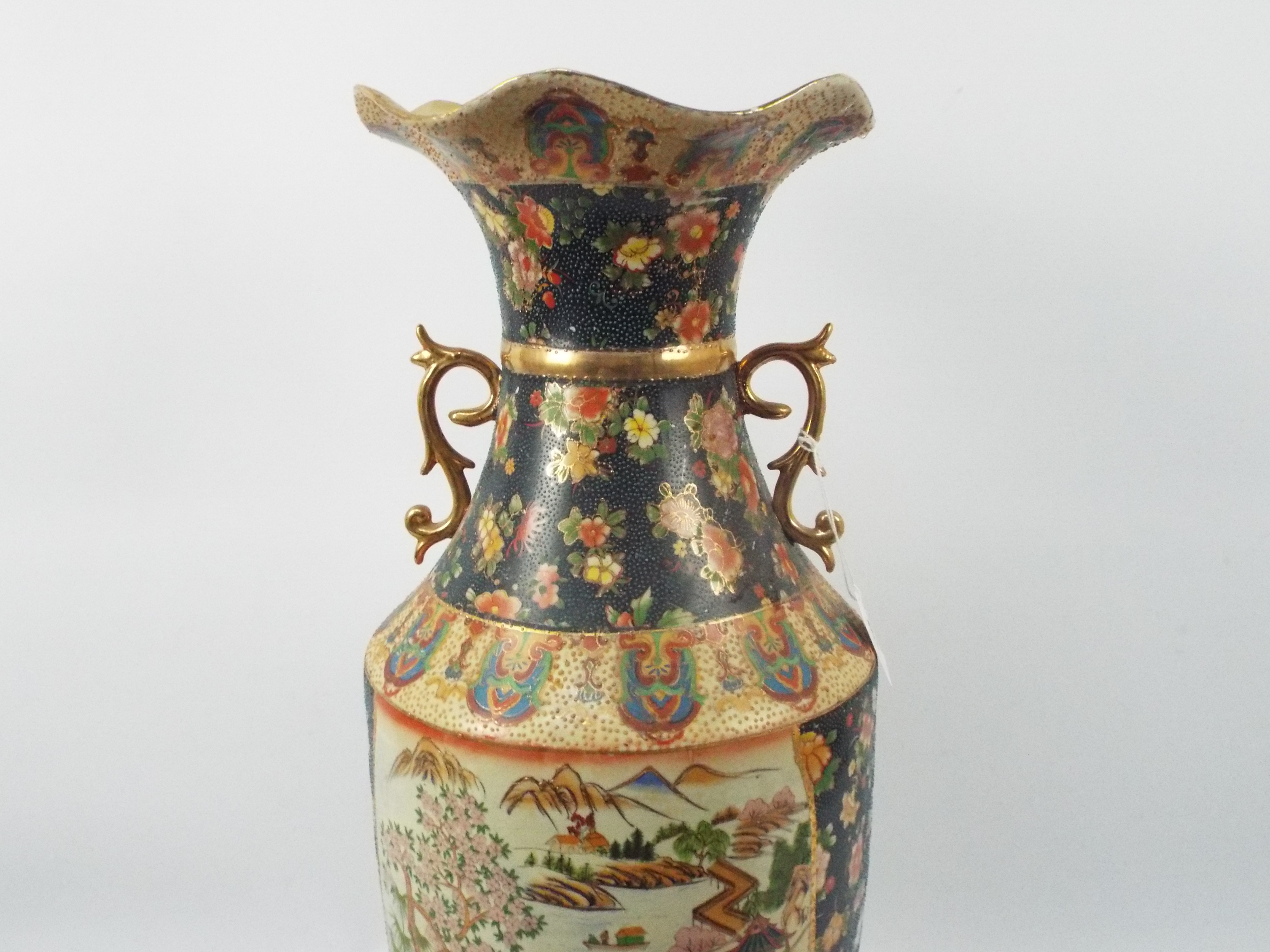 A large Japanese Satsuma ware vase with twin gilt handles decorated with two panels of figures in a - Image 2 of 10