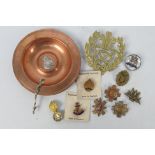 A collection of sweetheart brooches and similar and a copper dish with applied Metropolitan Special