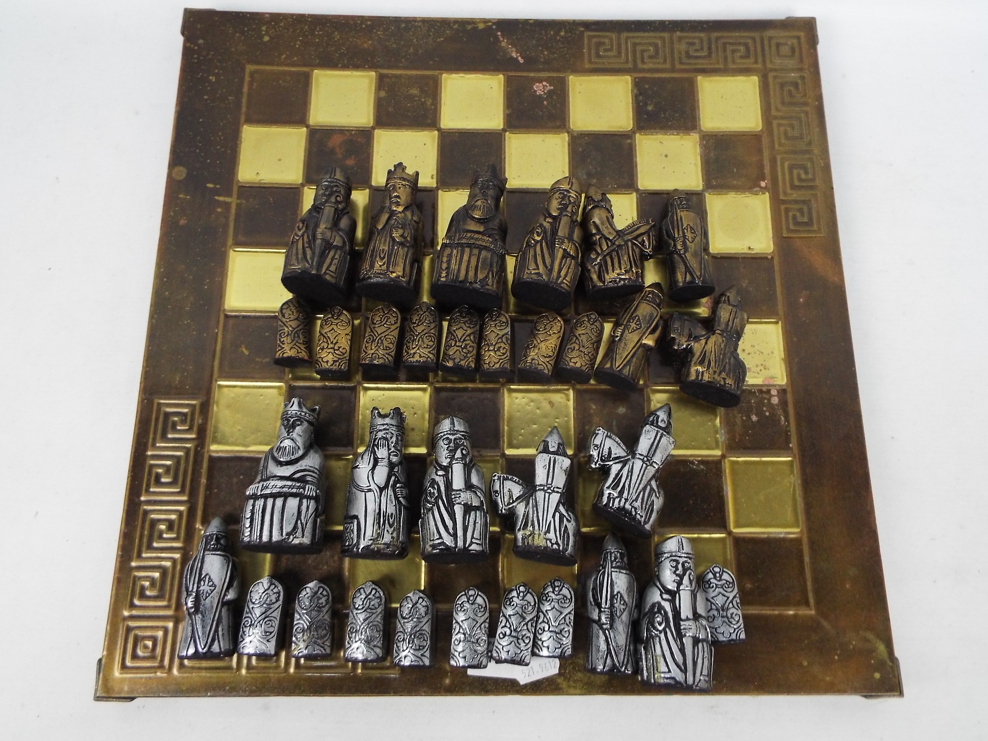 A chess board with a set of Uig / Isle Of Lewis chessmen, king approximately 8.5 cm (h).