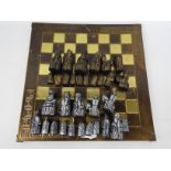 A chess board with a set of Uig / Isle Of Lewis chessmen, king approximately 8.5 cm (h).