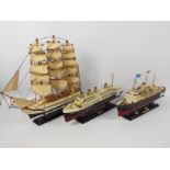 Three model ships raised on plinths to include Titanic, Britannia and other,