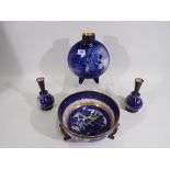 Doulton Burslem - Four pieces comprising a Willow pattern bowl raised on tripod supports, 24 cm (d),