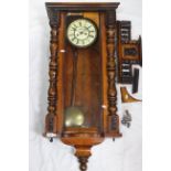 A Vienna-style weight-driven striking wall clock, walnut case with turned and applied decoration,