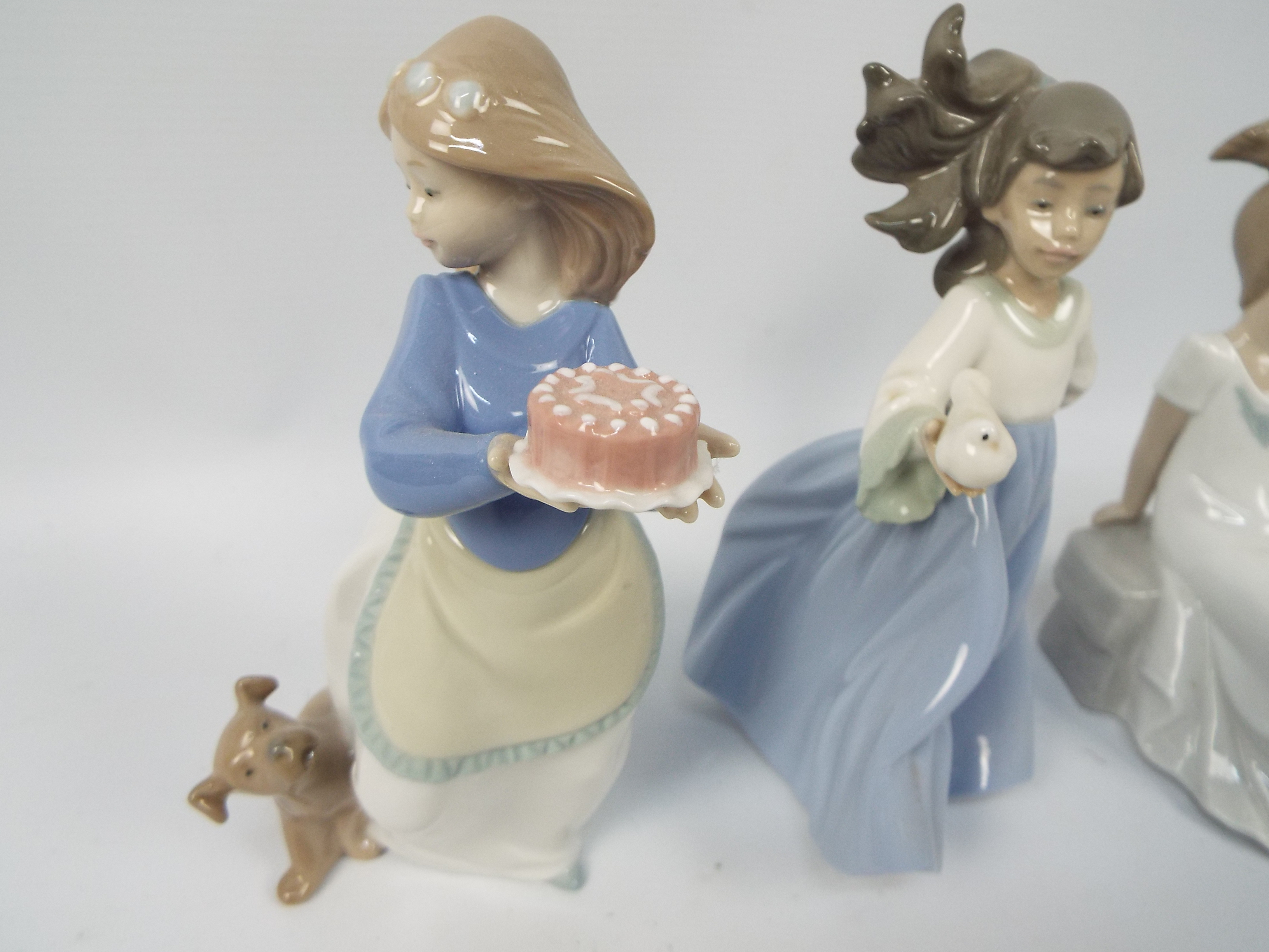 Three Nao figures of young girls with animals, largest approximately 19 cm (h). - Image 3 of 4