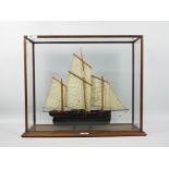 A scratch built model of a three masted lugger in glazed display,
