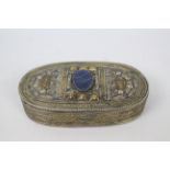 An Asian white and yellow metal trinket or jewellery box of oval section,