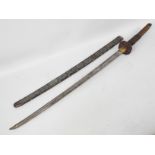 A vintage katana with 70 cm blade, foliate decorated tsuba and metal clad saya,