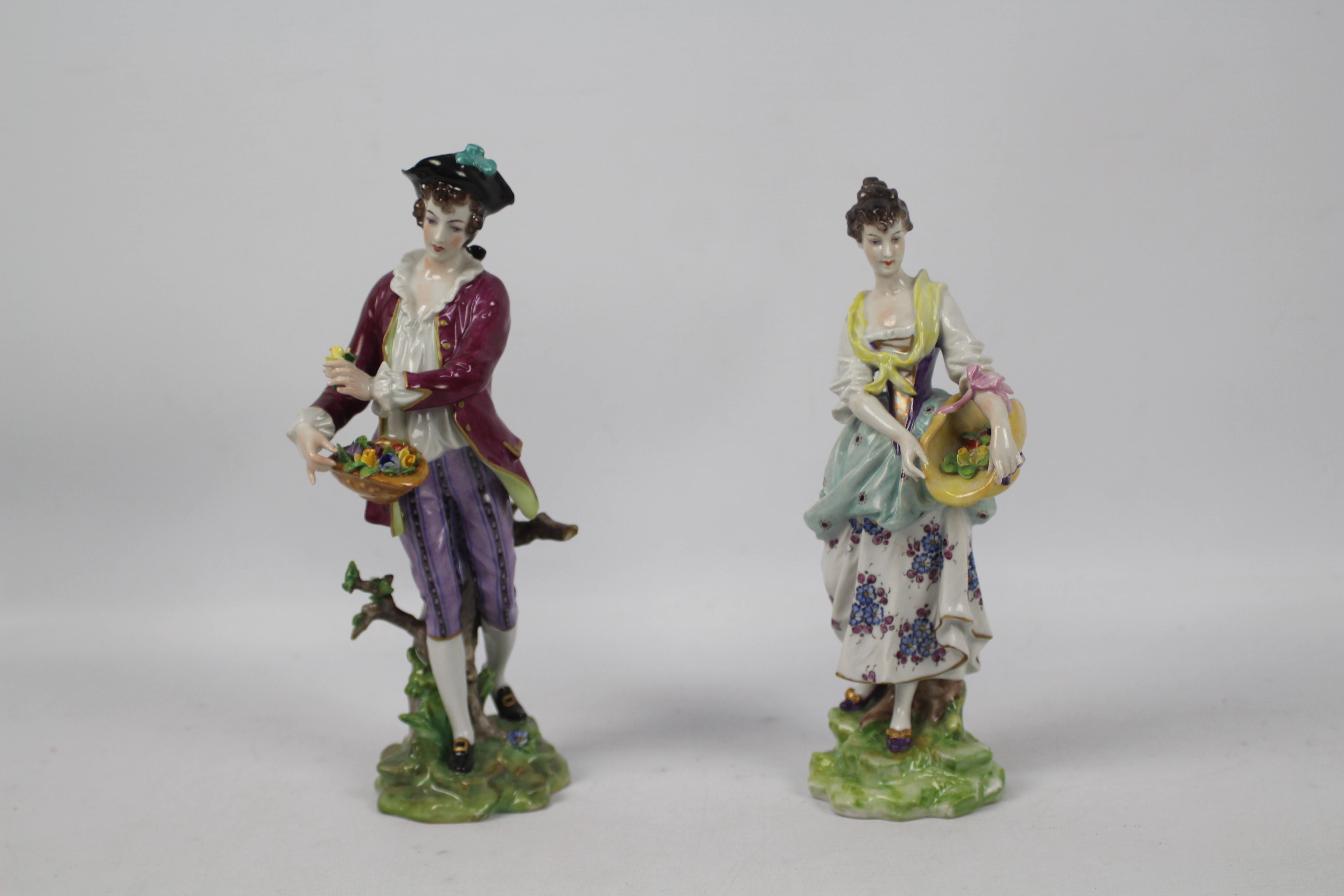 Volkstedt Porcelain - Two hand painted figures of flower pickers, one female, one male,