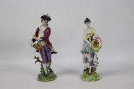 Volkstedt Porcelain - Two hand painted figures of flower pickers, one female, one male,