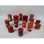 A collection of vintage tinplate money banks in the form of Post Office pillar boxes to include