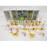 A collection of coloured glass animals comprising birds and fish.