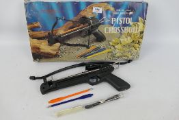 A boxed pistol crossbow with two plastic steel tipped bolts.