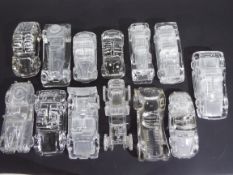 A collection of pressed glass paperweights in the form of motor cars
