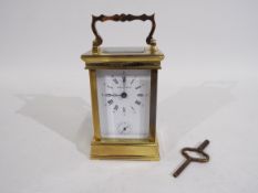 Boodle & Dunthorne - A French gilt brass and glass carriage alarm timepiece retailed by Boodle &