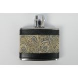 A 4oz stainless steel Liberty hip flask clad in leather bordered Hera fabric.