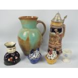 A group of ceramics to include a Prinknash Pottery jug (25 cm height), lidded stein, character jug,