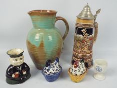 A group of ceramics to include a Prinknash Pottery jug (25 cm height), lidded stein, character jug,