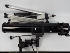A Celestron Firstscope 114 celestial telescope with tripod stand.