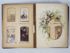 An antique album containing a collection of cabinet cards and cartes de visite.
