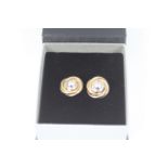 A pair of 9ct yellow and white gold earrings, approximately 4.2 grams all in.