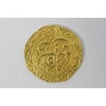 An Arabic gold coin, presumed 22ct, 2 cm (d), approximately 3.6 grams.