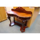 A mahogany, serpentine front, ledgeback console table with narrow central drawer,