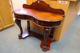 A mahogany, serpentine front, ledgeback console table with narrow central drawer,
