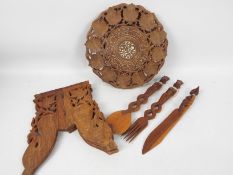 Ethnographica - A carved wood folding table with foliate decoration,