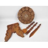 Ethnographica - A carved wood folding table with foliate decoration,