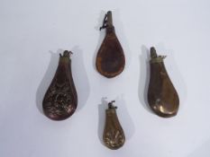 A group of four powder flasks comprising a leather example, three copper and brass,