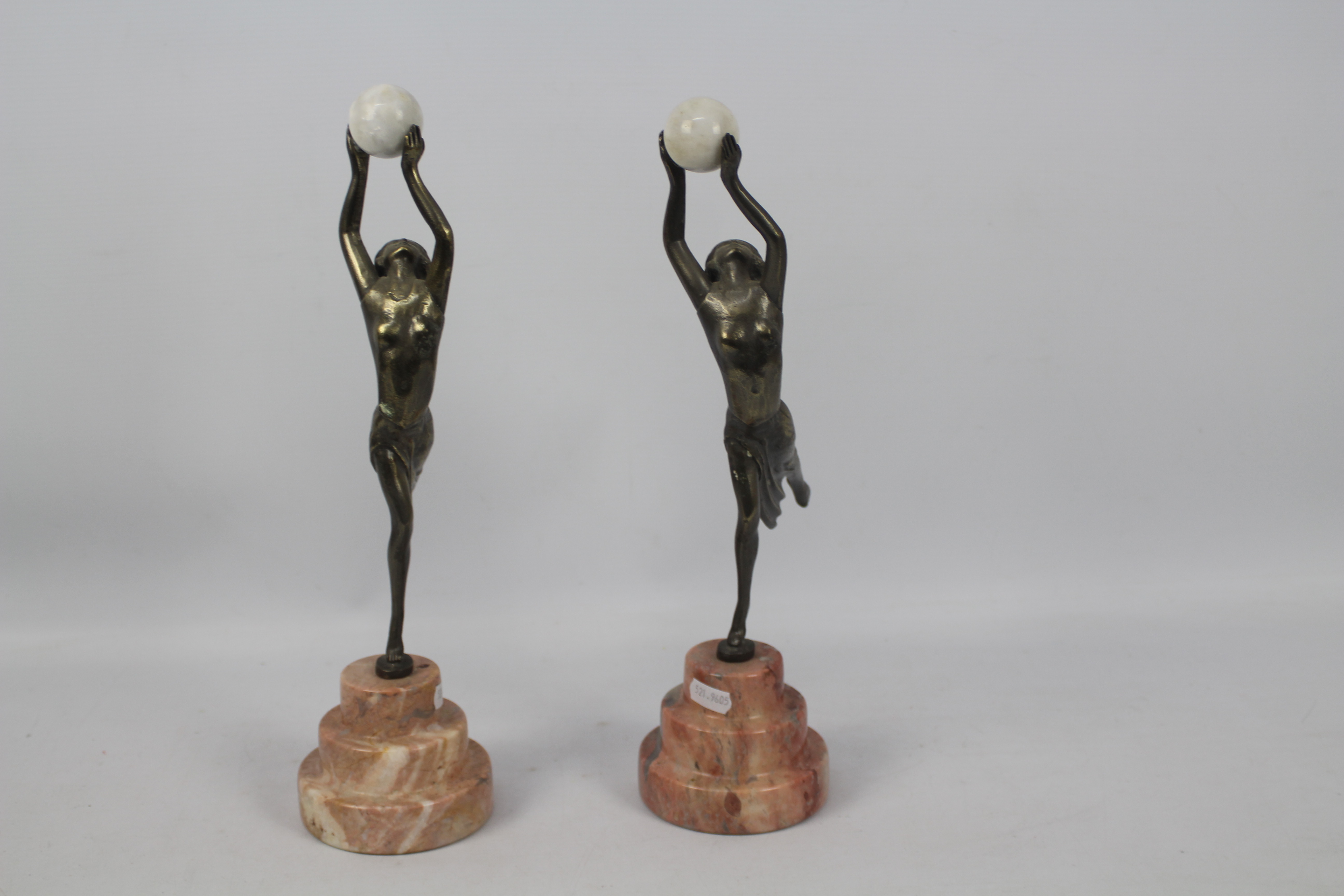 A pair of Art Deco style sculptures modelled as female figures holding aloft spheres, - Image 2 of 6