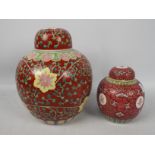 A large ginger jar and cover decorated with floral scrolls against a red ground,