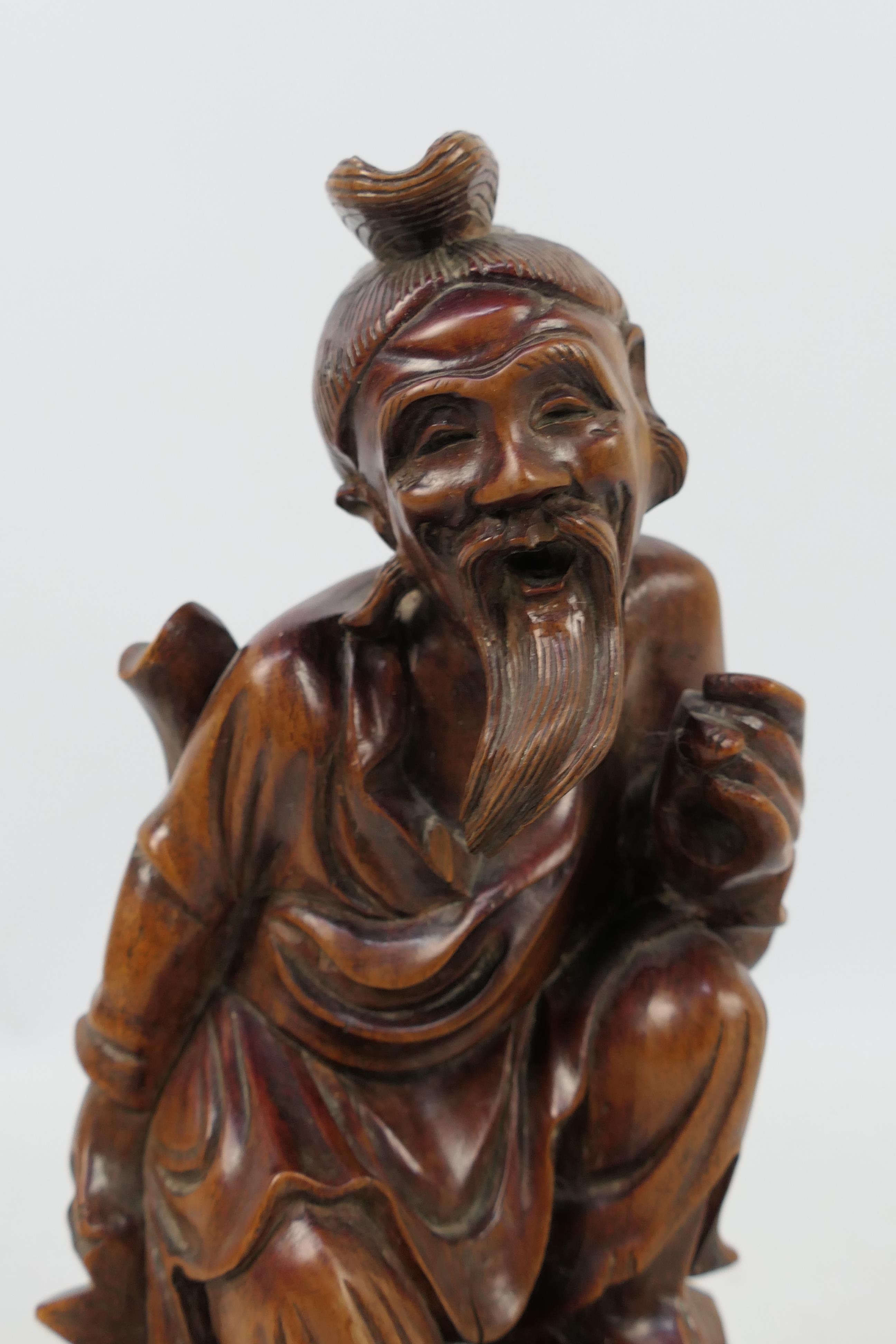 A carved wood figure depicting an elderly gentleman, approximately 24 cm (h). - Image 2 of 3