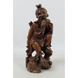 A carved wood figure depicting an elderly gentleman, approximately 24 cm (h).