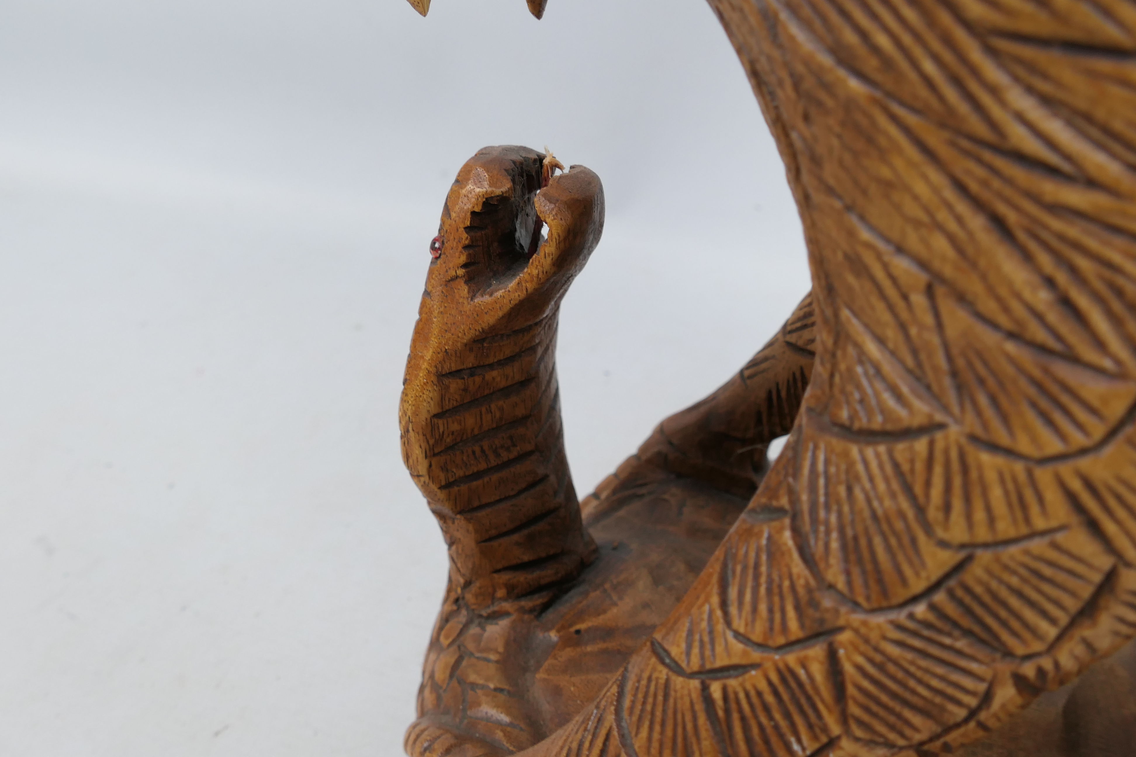 A large carved wood sculpture depicting an eagle attacking a cobra, - Image 3 of 4