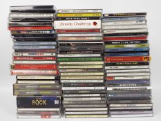 A box of compact discs to include The Beatles, Bob Dylan, ELO, Rolling Stones, Fleetwood Mac, REM,