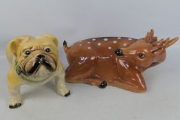 A large ceramic model of a deer, approximately 48 cm (l) and a model of a bulldog.