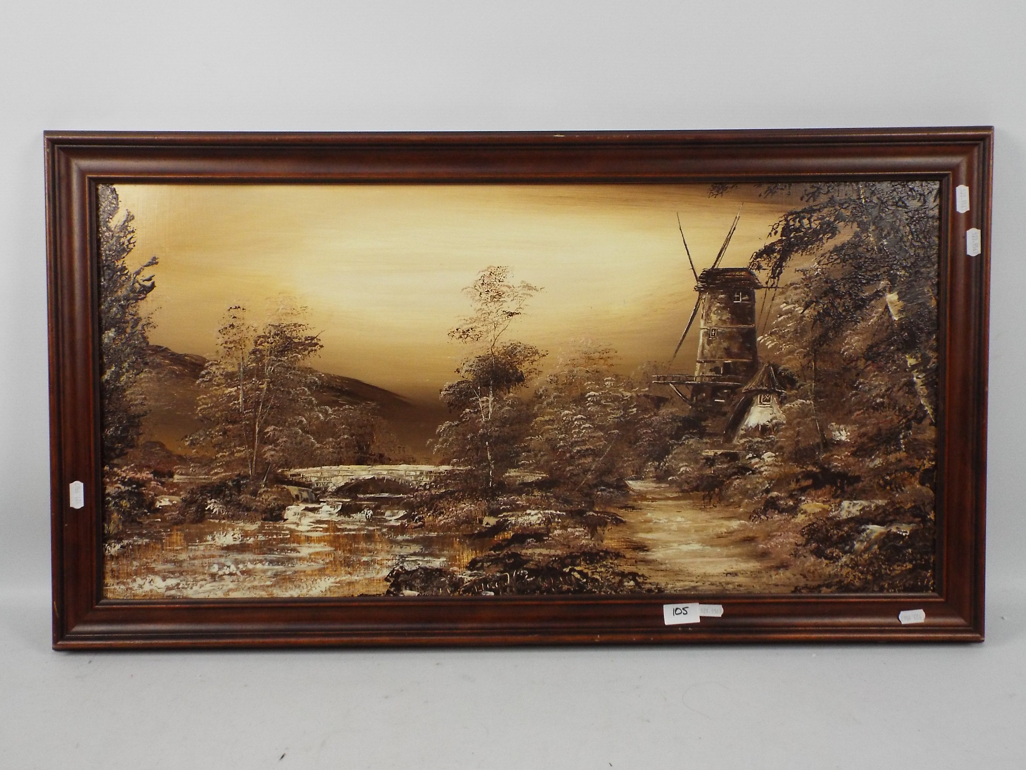 A framed oil on board landscape scene depicting a windmill by a path alongside a river,