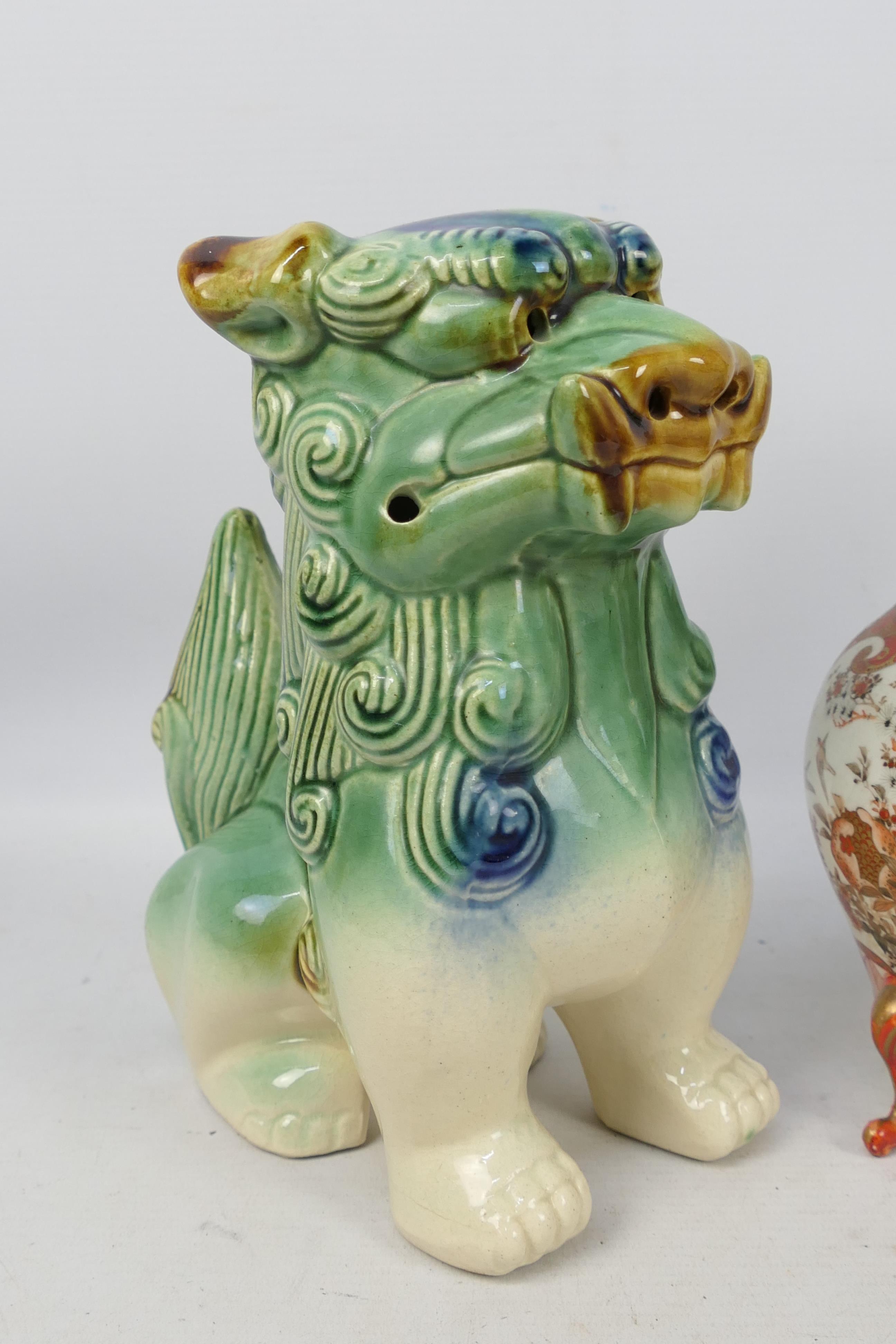 A pair of ceramic Buddhist lions, - Image 2 of 7