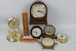 A collection of clocks and thermometers to include a Woodford mantel clock.