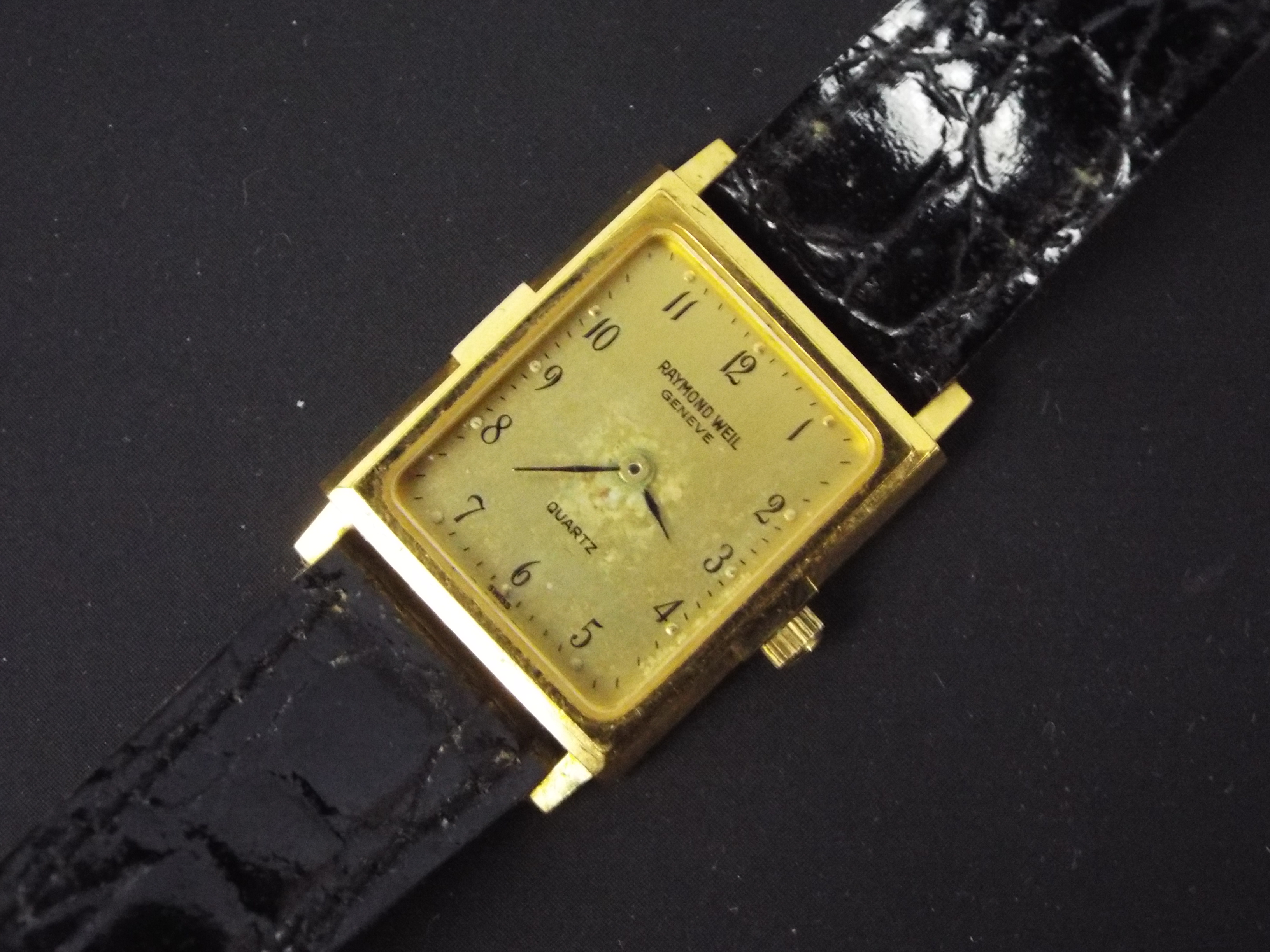 A lady's 18ct gold plated wrist watch on black leather strap.