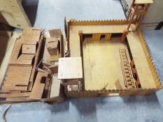 A wooden Fort Laramie playset and a further unconstructed fort playset, condition appears good,