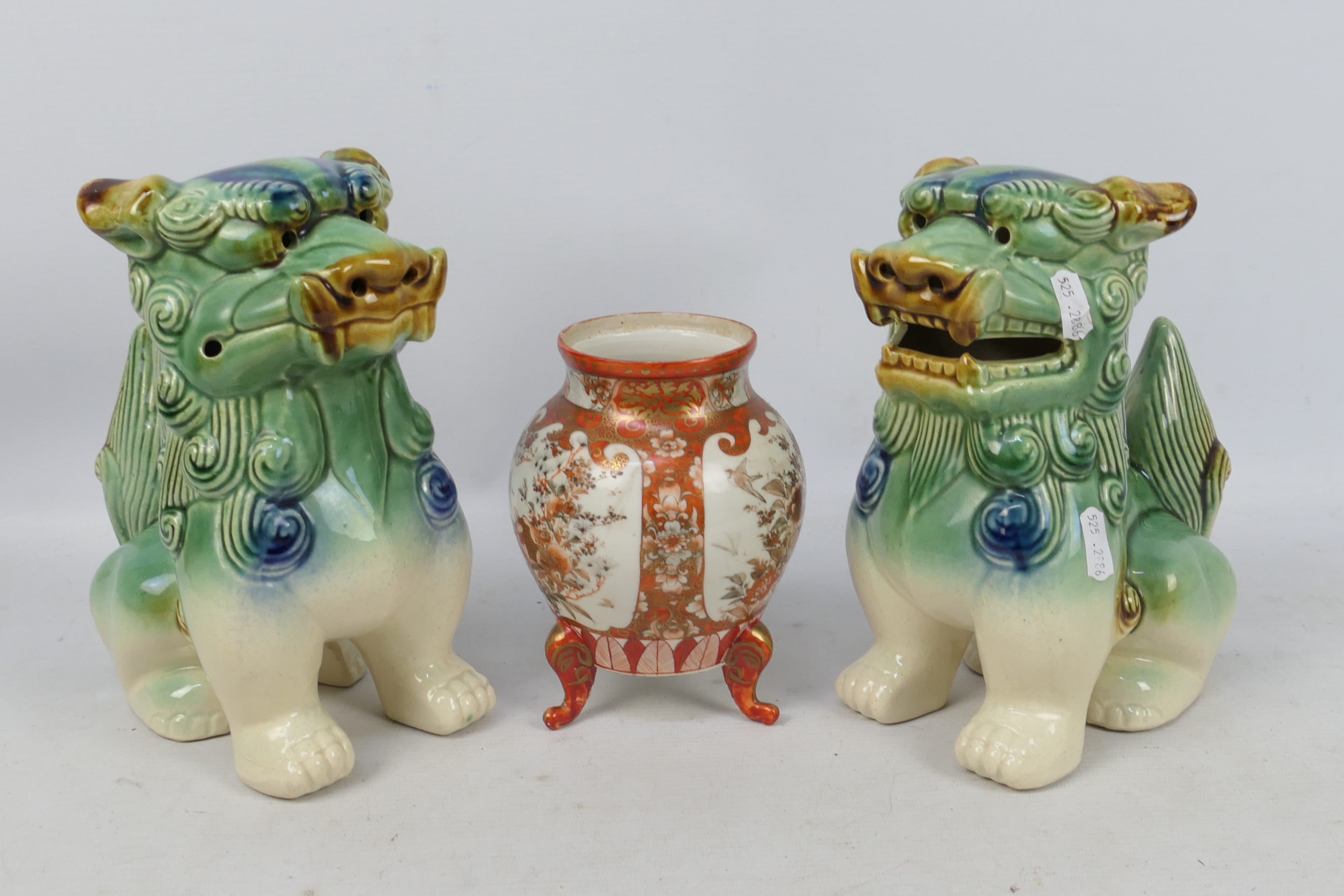 A pair of ceramic Buddhist lions,