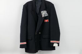 A vintage British Rail jacket with insignia and buttons and a hallmarked silver and enamel lapel