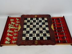 A Chinese style chess board and pieces with 9.5 cm (h) king.