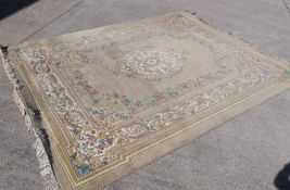 A large carpet with central medallion and floral border surround,