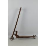 A vintage hand constructed wooden child's scooter with metal wheels, approximately 80 cm x 70 cm.