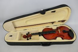 A cased violin and bow.