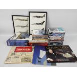 A collection of military related DVDs, books and similar.